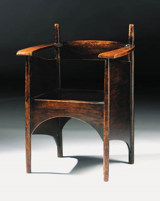 A dark stained oak armchair