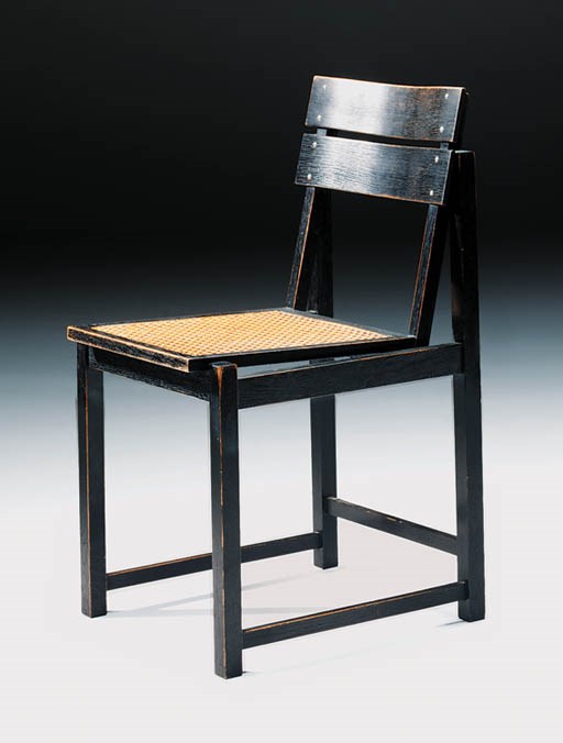 An ebonised and caned sidechair