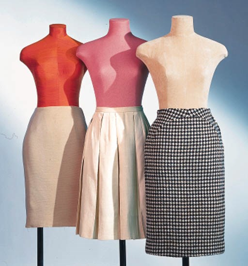A GROUP OF SIX SKIRTS AND ONE WOOL VEST