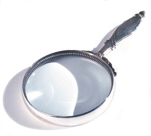 A MAGNIFYING GLASS AND A MAKE-UP CASE