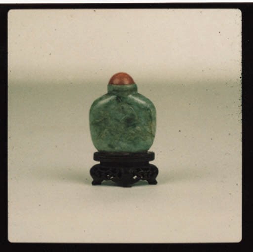 A CHINESE GREEN JADE AND CORAL SNUFF BOTTLE