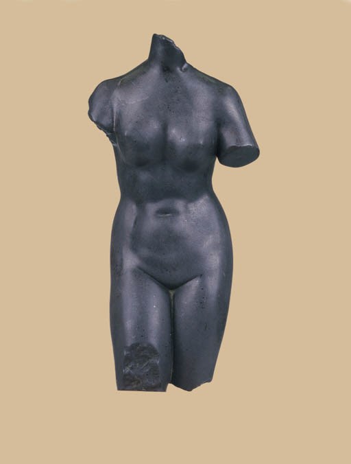 A CARVED GREY STONE FEMALE TORSO AFTER THE ANTIQUE