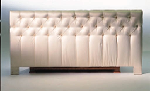 A QUILTED AND BUTTONED UPHOLSTERED HEADBOARD