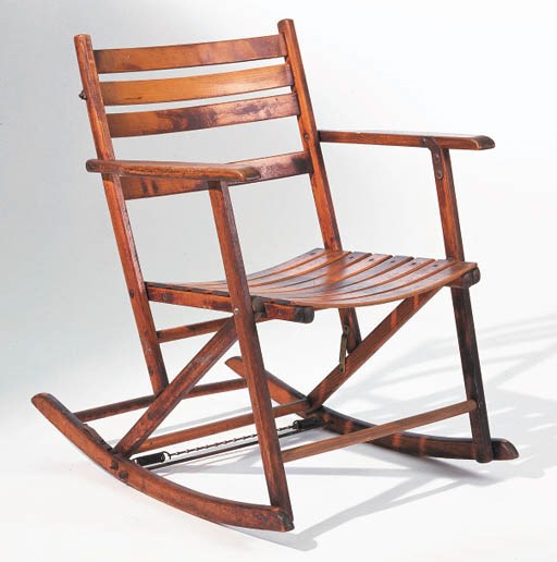 A STAINED WOOD FOLDING ROCKING CHAIR