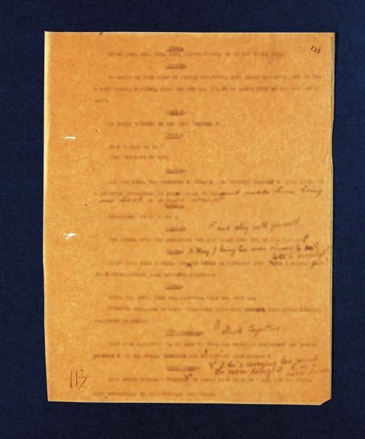 JOYCE, James. Typescript carbon page from the "Circe" episode of "Ulysses," WITH HOLOGRAPH ADDITIONS IN JOYCE'S HAND, comprising 39 words of additional dialogue; one of the interpolated passages with a single word ("see") deleted by Joyce and replaced with "take a snapshot of," the leaf with stamped foliation "115" at top right-hand corner, alternate foliation "113" in bold pencil (by Joyce's?) at lower left-hand corner. [Paris, circa 1921]. 1 page, 269 x 208mm., carbon typescript on thin, tan typing paper, two small punctures at right-hand margin where sheets were once fastened together, a tiny chip missing from lower right-hand corner, uniformly browned (as is the case with all the leaves on this rather poor-quality paper).