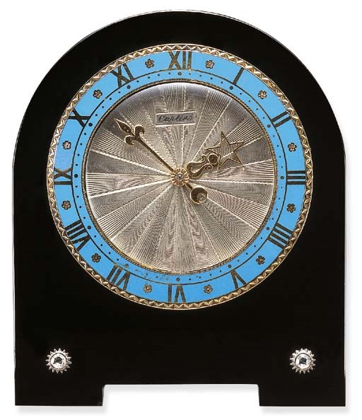 AN ART DECO ENAMEL, BLACK ONYX AND DIAMOND DESK CLOCK, BY CARTIER