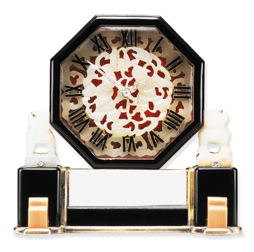 AN ART DECO CORAL, ROCK CRYSTAL, NEPHRITE JADE, BLACK ONYX AND ENAMEL DESK CLOCK, BY CARTIER