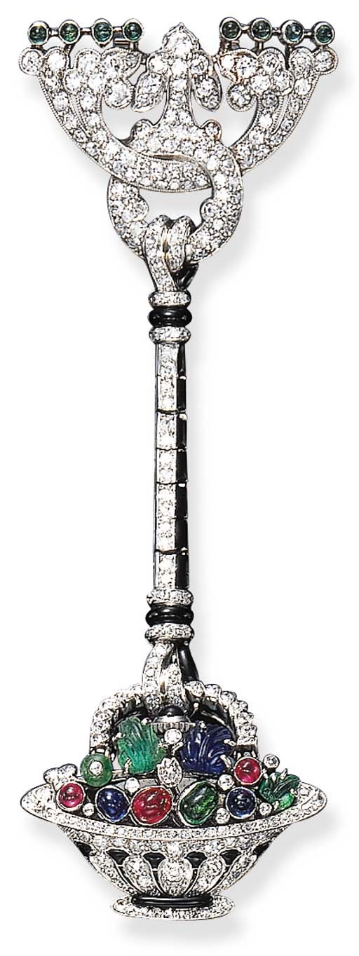 AN ELEGANT ART DECO DIAMOND AND GEM-SET LAPEL WATCH