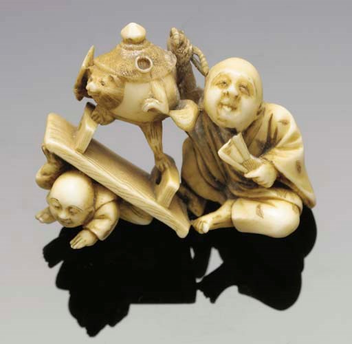 A Japanese ivory netsuke of a man and child, 19th Century