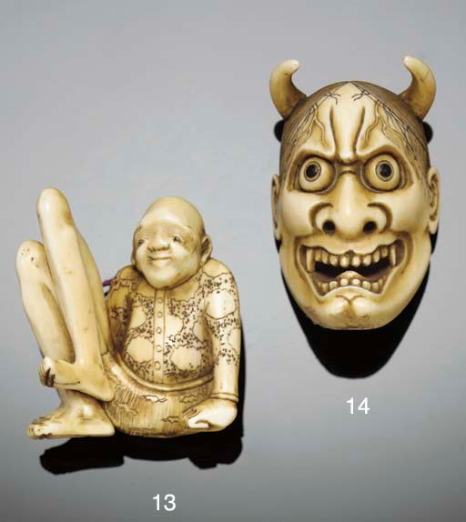 A Japanese ivory netsuke of a demon mask, 19th century