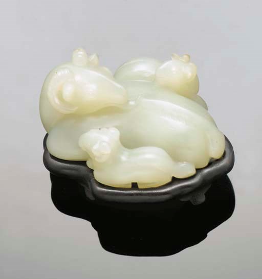 A celadon jade ram group, 17/18th Century
