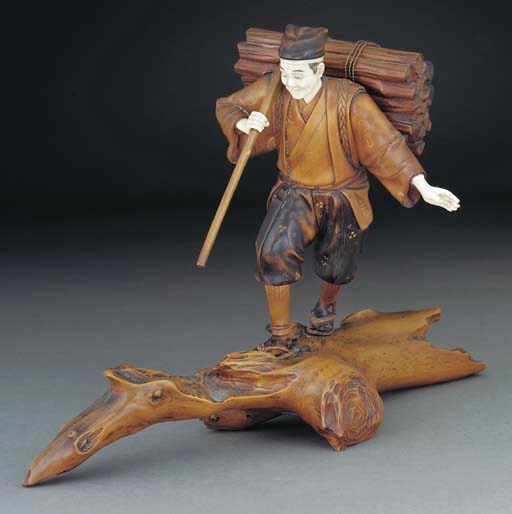A Japanese boxwood and ivory okimono of a farmer, Meiji period