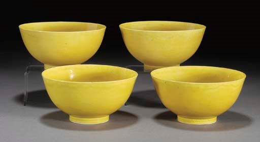 A set of four Chinese yellow glazed bowls, underglaze blue Xuantong six character marks and of the period