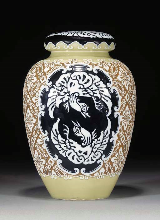 A Japanese olive, blue and brown moulded ovoid jar and cover, late 19th Century
