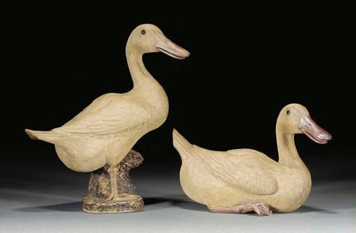 A pair of Japanese biscuit glazed pottery models of ducks, Meiji period