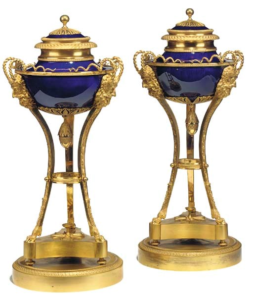 A PAIR OF EMPIRE ORMOLU-MOUNTED SEVRES BLEU LAPIS TRIPOD VASES