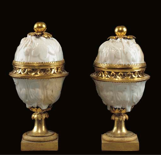 A PAIR OF LOUIS XVI ORMOLU-MOUNTED SOFT-PASTE BLANC-DE-CHINE PORCELAIN POT-POURRI VASES AND COVERS