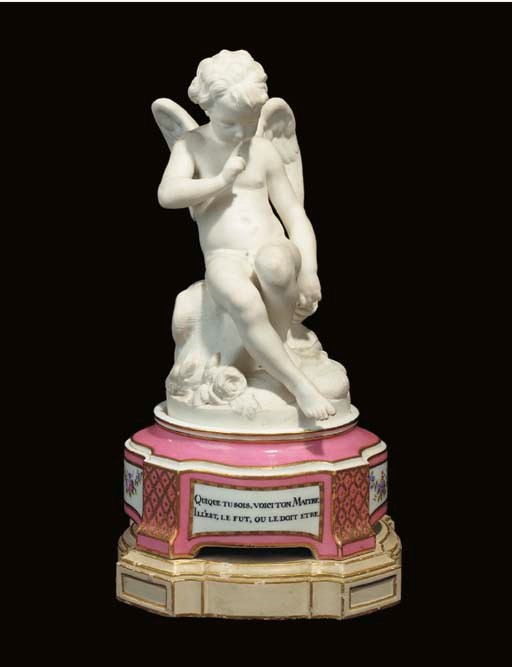 A SEVRES BISCUIT FIGURE OF CUPID ON A PEDESTAL