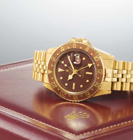 ROLEX. A FINE 18K GOLD AUTOMATIC DUAL TIME ZONE WRISTWATCH WITH CENTRE SECONDS, DATE, 24 HOUR INDICATION AND BRACELET