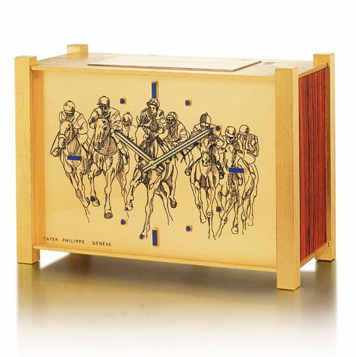 PATEK PHILIPPE. A RARE AND UNUSUAL GILT BRASS, WOOD AND LAPIS LAZULI-SET SOLAR POWERED DESK CLOCK WITH HORSE RACING ENGRAVED DIAL