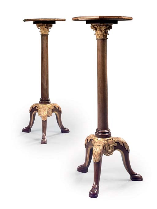 A PAIR OF PARCEL-GILT MAHOGANY TRIPOD TORCHERES