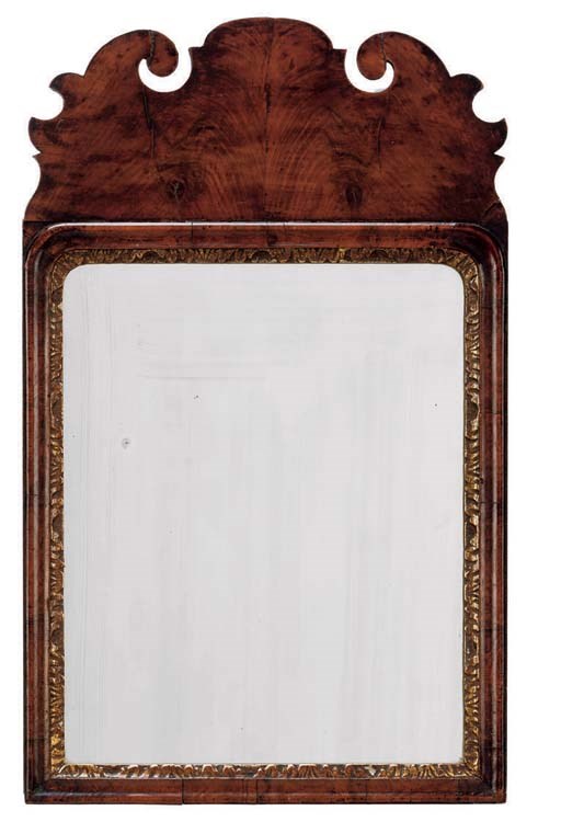 A GEORGE I WALNUT AND PARCEL-GILT MIRROR