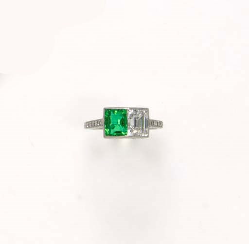 AN ART DECO TWO-STONE EMERALD AND DIAMOND RING, BY TIFFANY & CO.