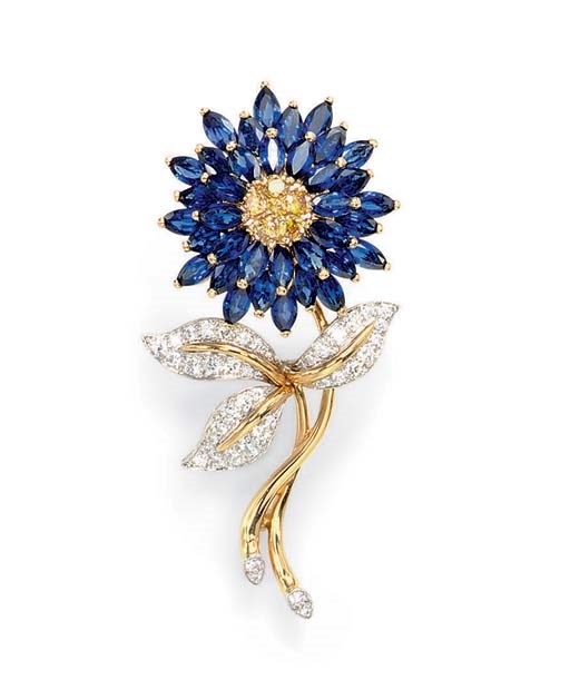 A SAPPHIRE AND COLORED DIAMOND BROOCH, BY OSCAR HEYMAN & BROTHERS