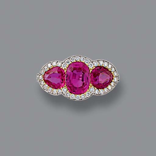 A THREE-STONE RUBY AND DIAMOND RING