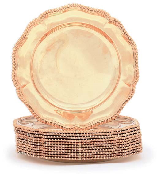 A SET OF TWELVE VICTORIAN SILVER-GILT DINNER-PLATES