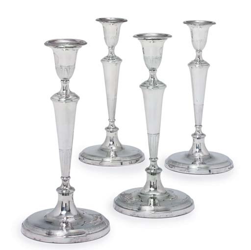 A SET OF FOUR GEORGE III SILVER CANDLESTICKS
