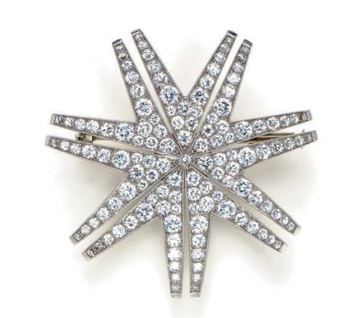 A DIAMOND, PLATINUM AND 18K WHITE GOLD STAR BROOCH, BY BURKS
