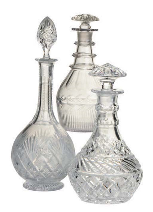 A PAIR OF GLASS DECANTERS AND STOPPERS AND A CUT-GLASS DECANTER AND STOPPER,
