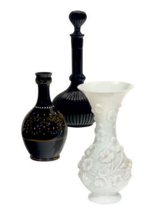 A CONTINENTAL GLASS VASE MOLDED WITH FLOWERS AND A GADROONED DECANTER AND STOPPER,