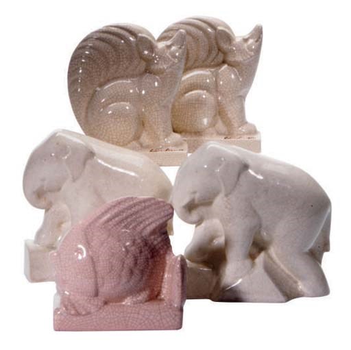 THREE PAIRS OF CONTINENTAL CRACKLE GLAZED FAIENCE BOOKENDS MODELED AS ANIMALS,