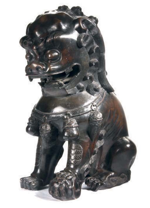 A BUDDHISTIC LION BRONZE,