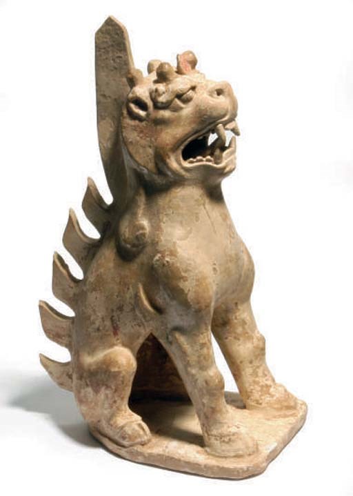 A CHINESE STRAW-GLAZED POTTERY MODEL OF AN EART,