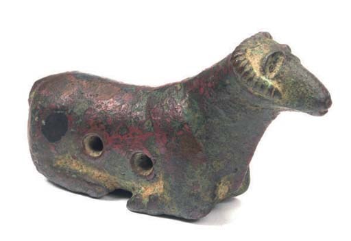 A SUMERIAN COPPER FIGURE OF A RECUMBENT RAM,