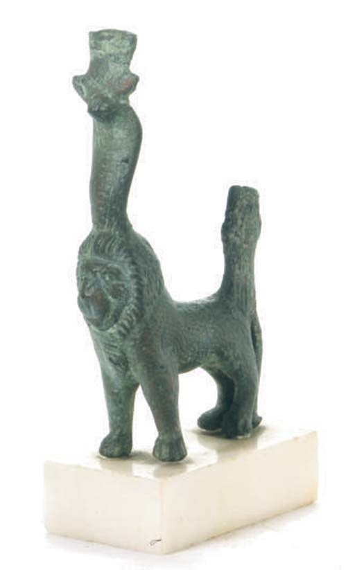 AN EGYPTIAN BRONZE LION,