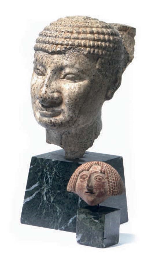 AN EGYPTIAN STYLE STONE HEAD OF AN OFFICIAL,