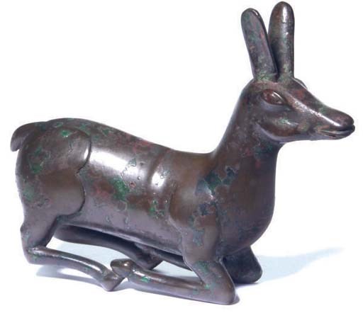 A SINO-SIBERIAN BRONZE RECUMBENT DEER,