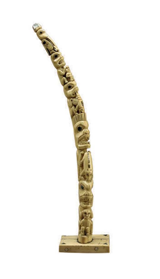 A NORTHWEST COAST CARVED WALRUS TUSK WITH ABALONE INLAY