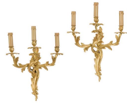 A SET OF FOUR GILT-BRONZE THREE LIGHT WALL APPLIQUES,