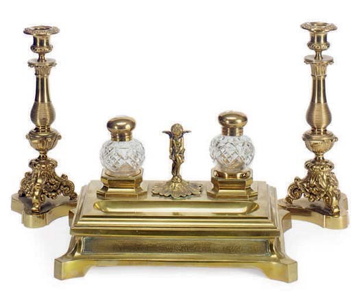 A PAIR OF BRASS CANDLESTICKS AND AN ENCRIER,