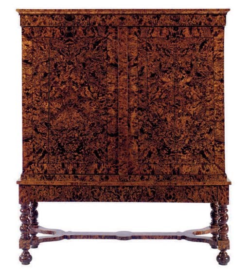 A NORTH EUROPEAN STAINED FIELD MAPLE OR MULBERRY CABINET ON STAND,