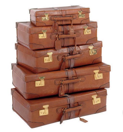 A SET OF FIVE GRADUATED LEATHER SUITCASES,