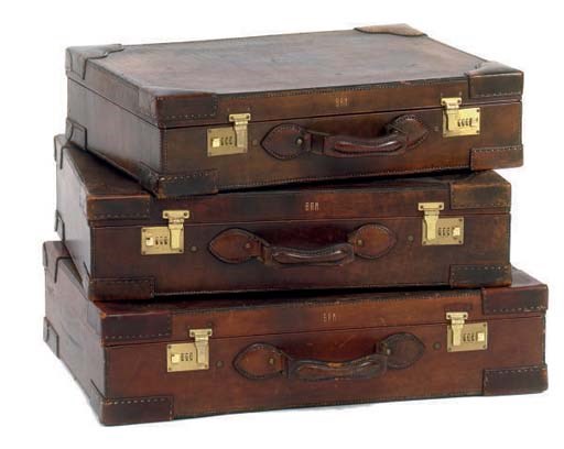 A SET OF THREE GRADUATED LEATHER SUITCASES,