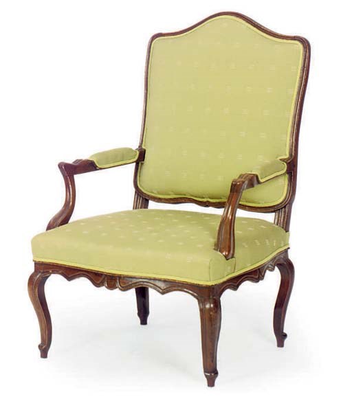 A FRENCH PROVINCIAL CARVED WALNUT FAUTEUIL,