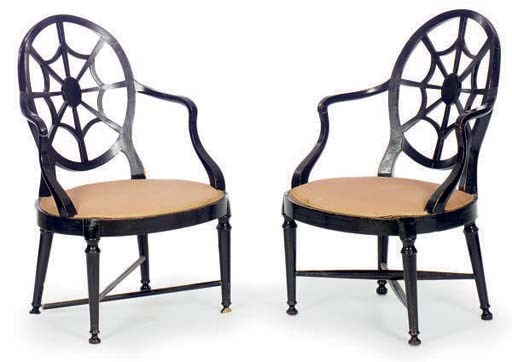 A PAIR OF ENGLISH EBONIZED SPIDERWEB DESIGN OPEN ARMCHAIRS,