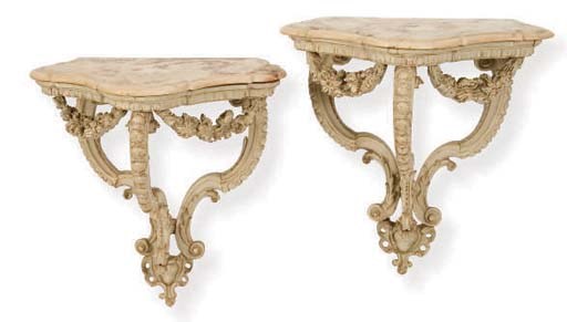 A PAIR OF ITALIAN CARVED AND WHITE PAINTED MARBLE TOP CONSOLE TABLES,